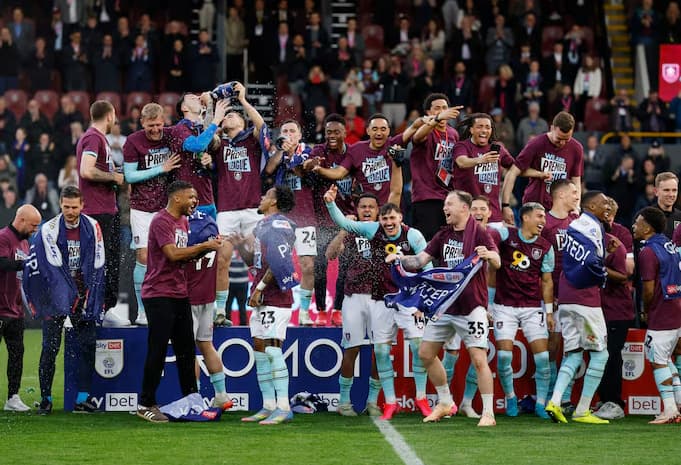 Burnley team celebrating promotion to the Premier League.